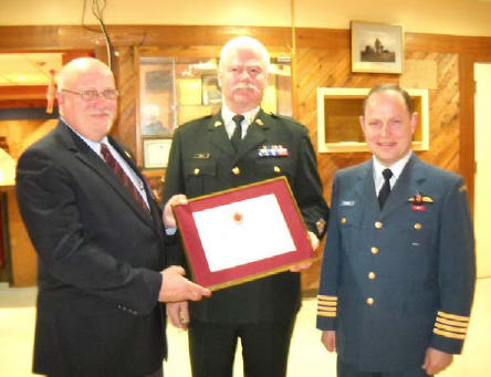 Col J.C. Benninger, 19 Wing Comox Commander and CWO K.P. Jones, CME Branch CWO, are presenting CWO D.N.F. Shavalier (Ret’d) with a CME Branch Commendation (certificate no 024) at the 192 CEF Aldergrove combined Mess on 15 December 2011.