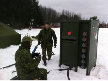 Cpl Kerr (electrical generating system tech) and Cpl Legendre (electrician), installing the power grid