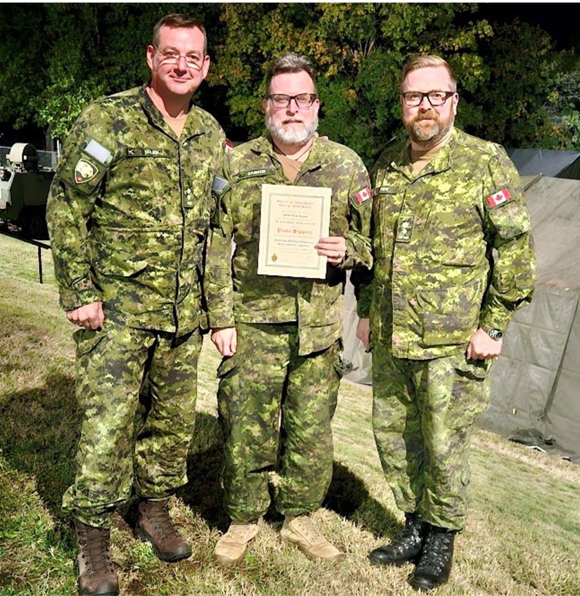 MWO Mark Gagnon, flanked by past CO, LCol J. Julien, and current CO LCol S Piers moments after his induction to the order on Friday 4 October 2004.