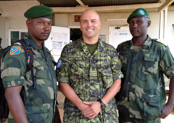 Senior Liaison Officer LCol JT Galuga was MONUSCO’s representative to the Forces Armées de la République Démocratique du Congo (FARDC), the national Congolese army, from June to December, 2014. He is pictured with two FARDC officers in the town of Mavivi in North Kivu, DRC in July, 2014. Photo courtesy of LCol JT Galuga / Le Lcol JT Galuga, officier supérieur de liaison, était le représentant de la MONUSCO auprès des Forces armées de la République Démocratique du Congo (FARDC), l’armée congolaise nationale 