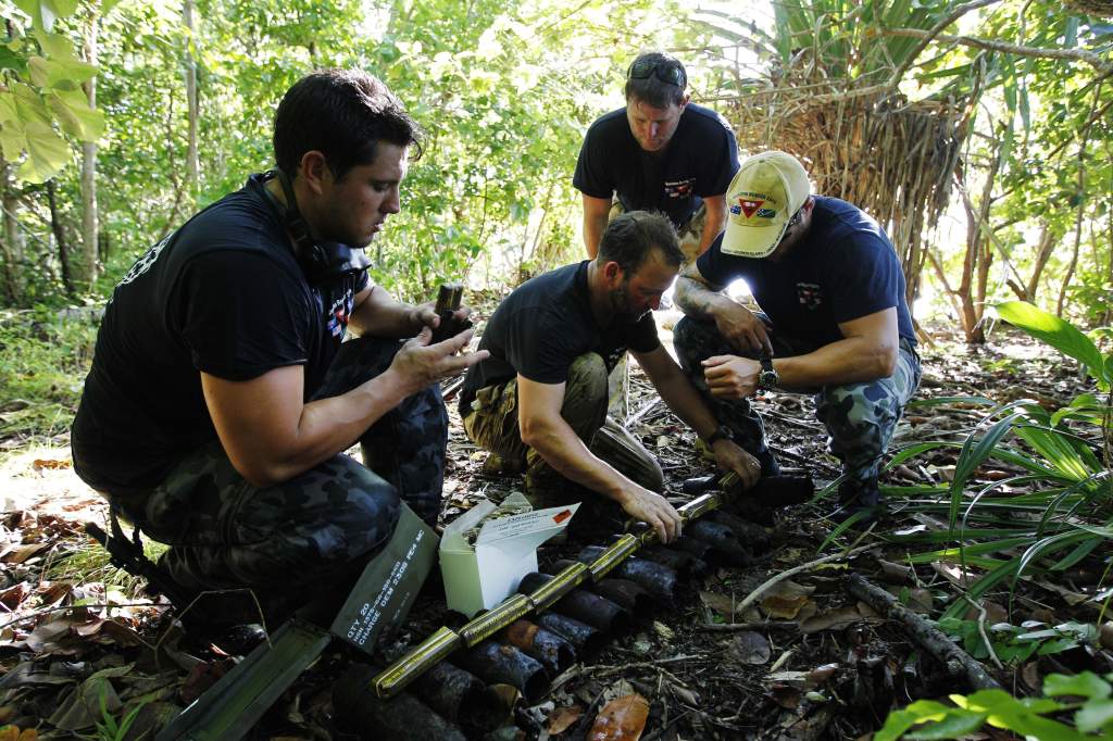 Royal Canadian Navy, Master Seaman Clearance Diver Shawn West (centre) calculates demolition charges required to clear unexploded ordnance in Russell Islands during Operation RENDER SAFE 2013 in Solomon Islands.
