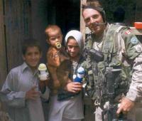 A Canadian soldier‎ in Afghanistan giving Izzy Dolls to children