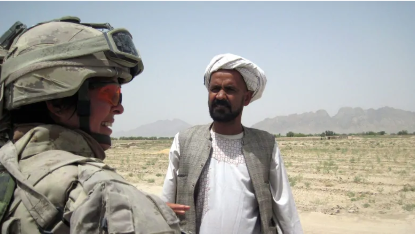 Lt.-Col. Jennie Carignan speaks to area resident Yar Mohammad about a retaining wall project near his village along the Tarnak River in the Dand Distrct of Kandahar province in August, 2010. Carignan, now a brigadier general, has been assigned command of the NATO training mission in Iraq. (Dene Moore/The Canadian Press)