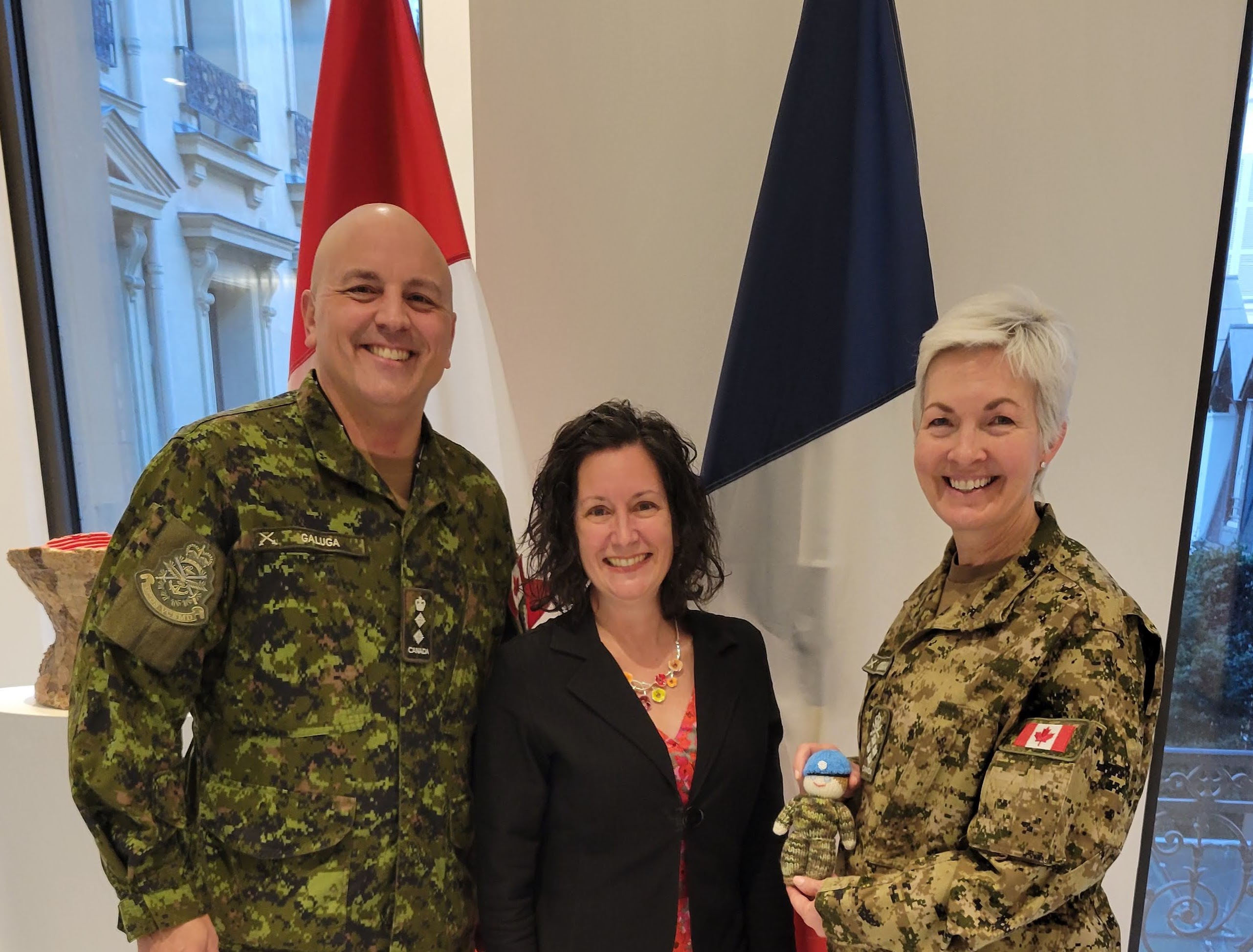 Lise Galuga, spouse of Col Jake Galuga, Miliary Attaché in Paris, presents Gen Jennie Carignan with and Izzy Doll