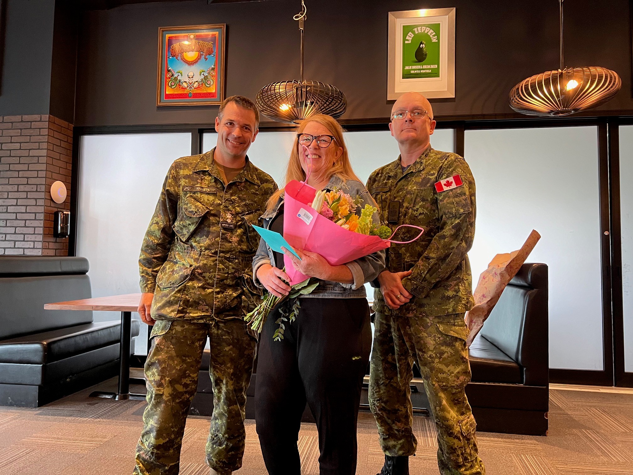 CO & RSM presenting flowers to Lee Campbell thanking her services as a public servant. (L-R) RPOU(W) CO, LCol Johnathan Hallett, Executive Assistant, Lee Campbell, RPOU(W) RSM, CWO Eric Barney. Photo by Capt Kyle Ho