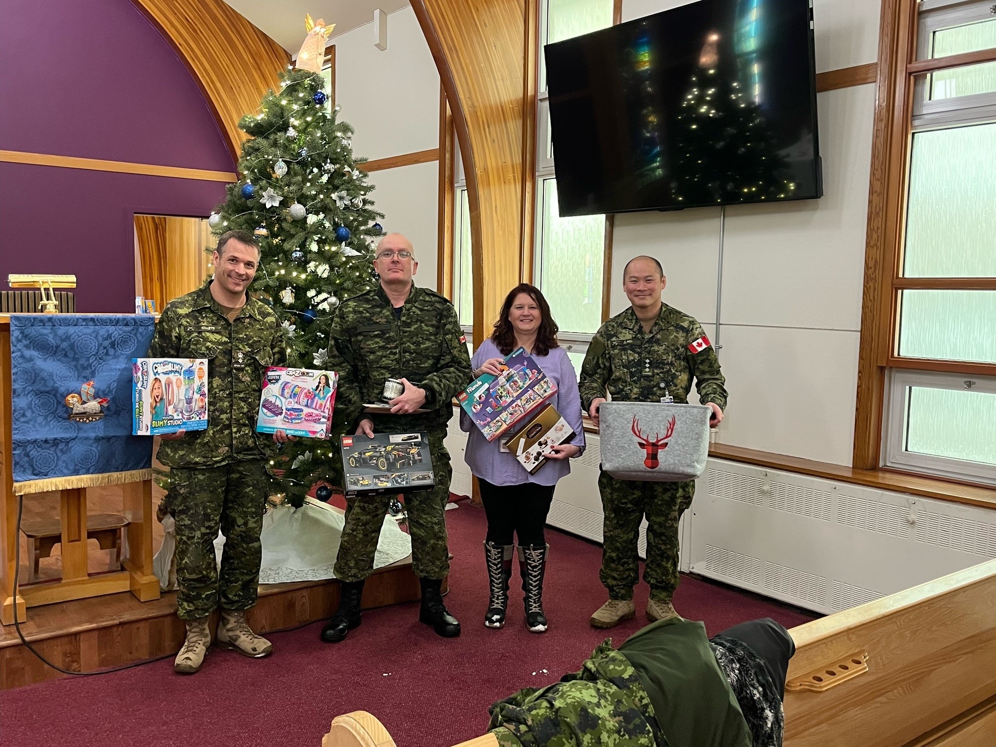 A Heartwarming Community Effort – (L-R) RPOU(W) CO, LCol John Hallett, RPOU(W) RSM, CWO Eric Barney, RPOU(W) Assistant Administrative Officer, Angela Richard, and RPOU(W) Operations Officer, Capt Kyle Ho at the base Church, CFB Edmonton. Photo by: Michelle Cure, Chapel Admin