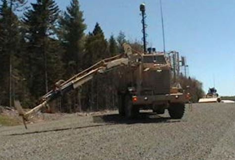 An arm operator from the Buffalo exercising further investigation to find an Improvised Explosive Device (IED)