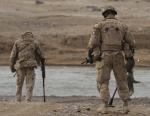 A typical engineer clearance operation on foot with mine detectors at a ford or crossing place.
