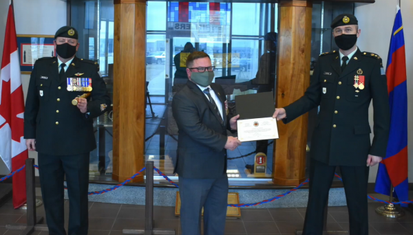 Cpl Kyle Scott, (Ret'd) receives CME Commendation from LCol Clarke, CO 1 CER, on behalf of the Colonel Commandant, BGen Steve Irwin and the Branch Chief, CWO Stacey Merriam