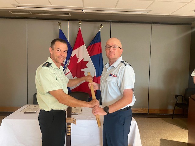 LCol Johnathan Hallett receives the RPOU-W UCWO pace stick from CWO Eric Barney. The image captures the transition of responsibility and tradition with a sense of reverence and the weight of history. Photo by Maj Michael Mueller