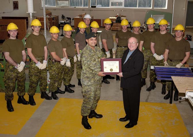Mr Leslie presents LCol Gupta with CCTT accreditation certificate in front of QL 3 Construction Technician Apprentice Course at CFSME: (L to R) Cpl RC Stanutz, Pte RC Penney, Cpl CJ Gibson, Cpl JR McKinley, Cpl MM Conrad, Sgt JD Rudy (Course NCO), Cpl SC Gallant, Cpl MC Sheppard, Cpl K Turner, Cpl DW Adshade, Cpl RA Walker, Pte KF Hynes and Cpl TR Harper.