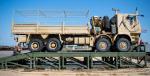 A member of the IST cleans an AHSVS up on vehicle ramps placed inside of a fuel berm. Photo Credit: Avr LeVasseur-Pearce, TFL Image Tech