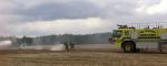 During the QL6 Supervisor Course, Lieutenant Jenson Gilby, on the nozzle, and Sergeant Matthew Mitton, on the hose, extinguish spot fires after a simulated aircraft crash at the Canadian Forces Fire and Nuclear, Biological and Chemical Academy at CFB Borden, Ontario. PHOTO: Courtesy of Lieutenant Jenson Gilby