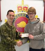 Capt Kevin Elmer presenting a bursary cheque to Matthew Burgess, son of CMEA member Maj Peter Burgess (Ret'd).