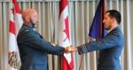 Chief Warrant Officer Dean Scanlan being presented with the RPOU(P) Unit Drill Cane from the new CO, Lieutenant-Colonel Michael Ulloa, to finalizing his appointment as the RPOU(P) CWO.