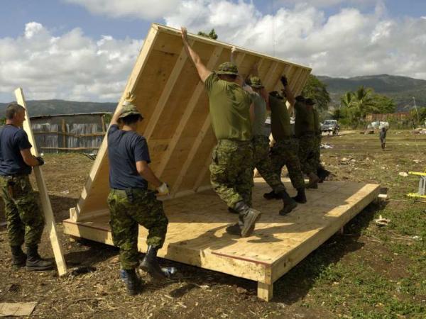 This 2010 photo shows members of the 74 Construction Troop from 4 Engineering Support Regiment building a structure for an orphanage in Haiti. DND photo.
