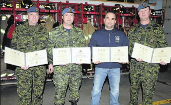 (Left to Right) Cpl Wayne Fraser, MCpl Andy Matthews, Sgt (Ret'd) Neil Cristo, and Cpl John Mac DonaId hold their Commander's Commendations following the presentation by Colonel Stephen Lacroix, Comd 3 CDSG, and CWO James Doppler,