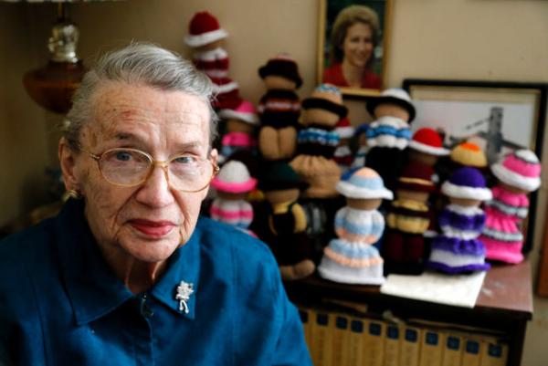 Joan Anstead sits next to a shelf full of Izzy Dolls she knitted for the national project at her home near Roebuck on Thursday. (DARCY CHEEK/The Recorder and Times)