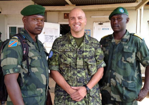 Senior Liaison Officer LCol JT Galuga was MONUSCO’s representative to the Forces Armées de la République Démocratique du Congo (FARDC), the national Congolese army, from June to December, 2014. He is pictured with two FARDC officers in the town of Mavivi in North Kivu, DRC in July, 2014. Photo courtesy of LCol JT Galuga / Le Lcol JT Galuga, officier supérieur de liaison, était le représentant de la MONUSCO auprès des Forces armées de la République Démocratique du Congo (FARDC), l’armée congolaise nationale