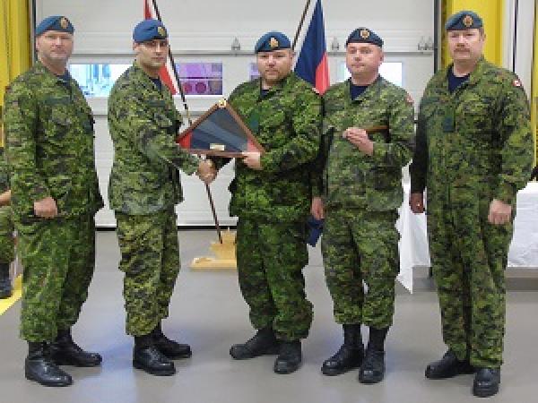 From left to right to left, MWO Bungay (Deputy Fire Chief), MWO Robar (14 Wing CE MWO), Cpl Ray Lambe, Major Button (14 Wing CEO), and MWO Knight (Deputy of Operations).