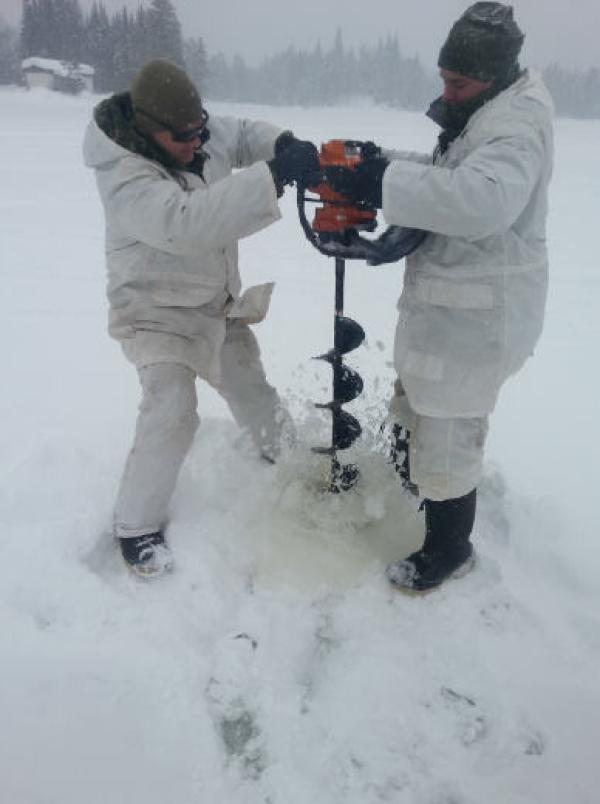 Members from 51e squadron of 5 CER are drilling a hole through the ice layer that formed over Lake Hayes in order to install water pumps.