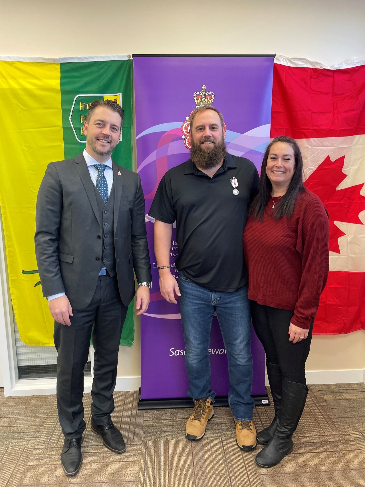 (L-R):MLA Moose Jaw North, Hon. Tim McLeod, QPJM Recipient, WO Brian White, and WO White’s spouse, Amanda Johnston. Photo by: Capt Pavlo Besedin